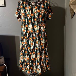 NWT Lularoe Hi-Lo dress in orange/green print on black/cream background. Sz XL.
